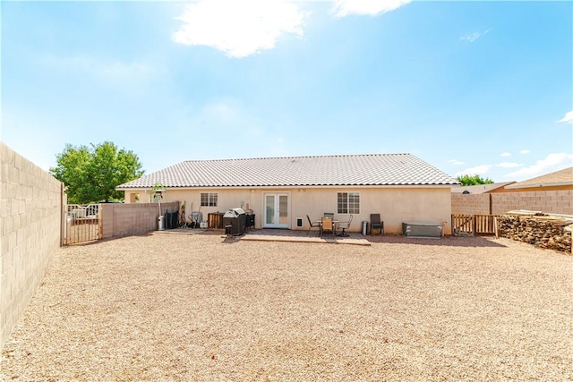 3048 Mallory Loop, Kingman, AZ 86401 - rear view of house featuring a gate, a fenced backyard, stucco siding, a patio area, and french doors