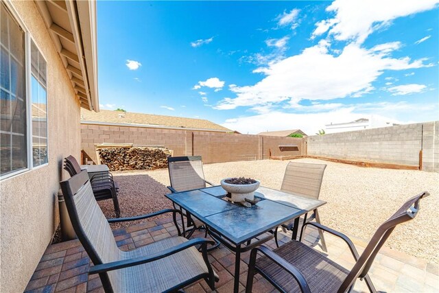 3048 Mallory Loop, Kingman, AZ 86401 - fenced backyard with outdoor dining area, a patio area, and a fire pit