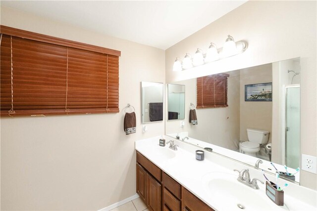 3048 Mallory Loop, Kingman, AZ 86401 - full bath featuring toilet, double vanity, a shower with door, baseboards, and tile patterned floors