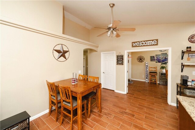 3048 Mallory Loop, Kingman, AZ 86401 - dining area with ceiling fan, vaulted ceiling, baseboards, arched walkways, and wood finished floors