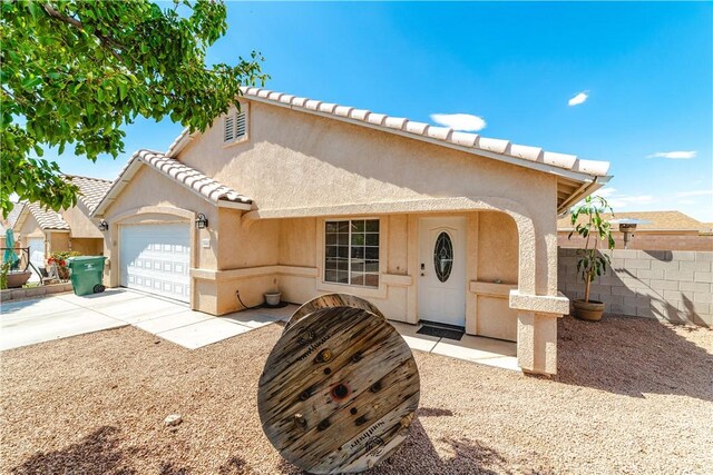 3048 Mallory Loop, Kingman, AZ 86401 - mediterranean / spanish-style home with stucco siding, a garage, driveway, and a tile roof