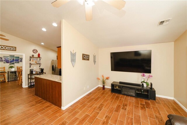 3048 Mallory Loop, Kingman, AZ 86401 - living area featuring a ceiling fan, baseboards, wood finished floors, recessed lighting, and lofted ceiling