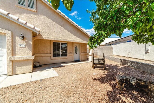 3048 Mallory Loop, Kingman, AZ 86401 - exterior space featuring stucco siding and a patio area