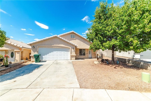 3048 Mallory Loop, Kingman, AZ 86401 - view of front of home with stucco siding, driveway, an attached garage, and a tile roof