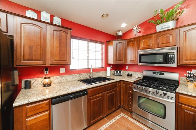 3048 Mallory Loop, Kingman, AZ 86401 - kitchen with stainless steel appliances, a sink, vaulted ceiling, light tile patterned floors, and recessed lighting