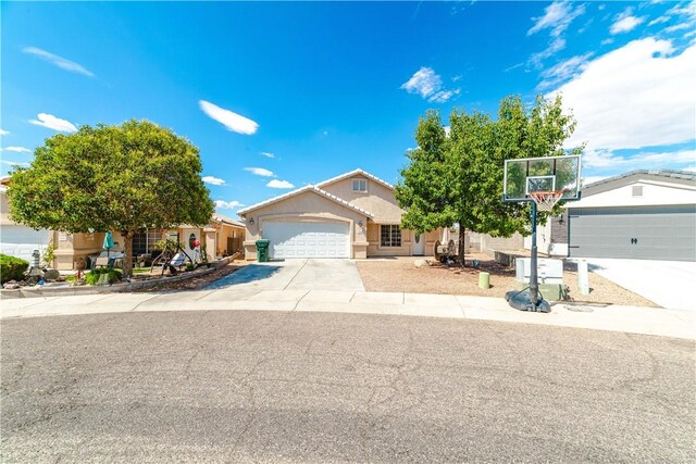 3048 Mallory Loop, Kingman, AZ 86401 - view of front of house featuring driveway, a garage, and stucco siding