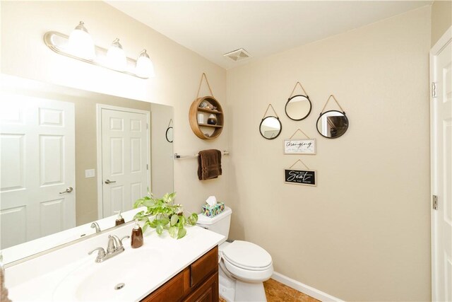 3048 Mallory Loop, Kingman, AZ 86401 - bathroom featuring vanity, toilet, tile patterned flooring, and baseboards