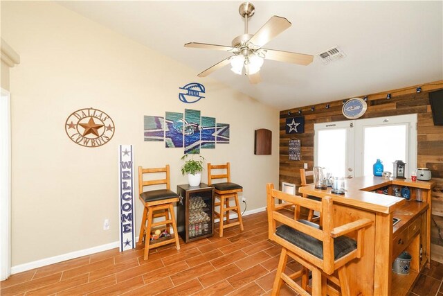 3048 Mallory Loop, Kingman, AZ 86401 - dining space with wooden walls, baseboards, a ceiling fan, and wood finished floors