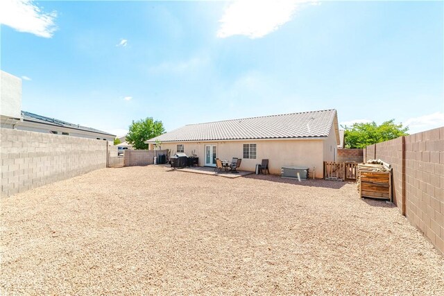 3048 Mallory Loop, Kingman, AZ 86401 - rear view of house featuring a fenced backyard, stucco siding, a patio area, and a tiled roof