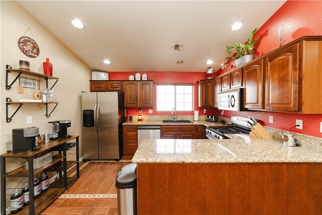 3048 Mallory Loop, Kingman, AZ 86401 - kitchen with appliances with stainless steel finishes, a sink, a peninsula, recessed lighting, and light stone countertops