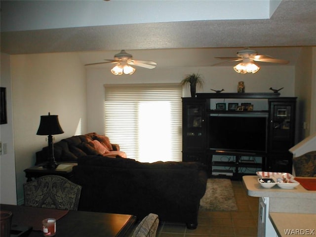 living room featuring a textured ceiling, a ceiling fan, and tile patterned floors