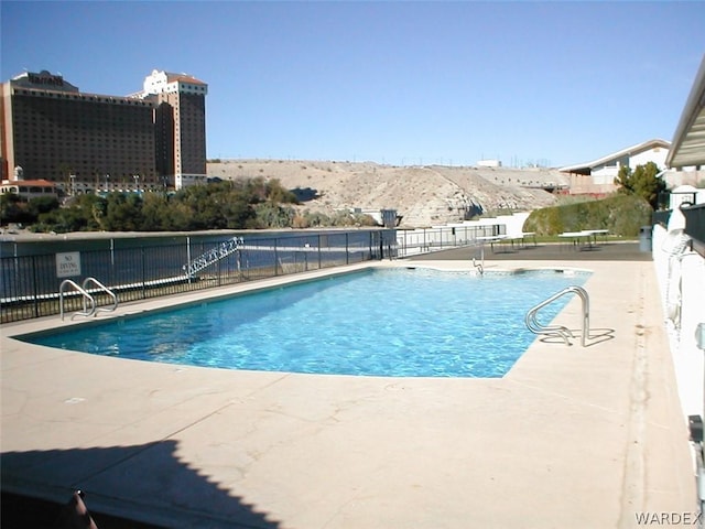 pool featuring a patio area and fence