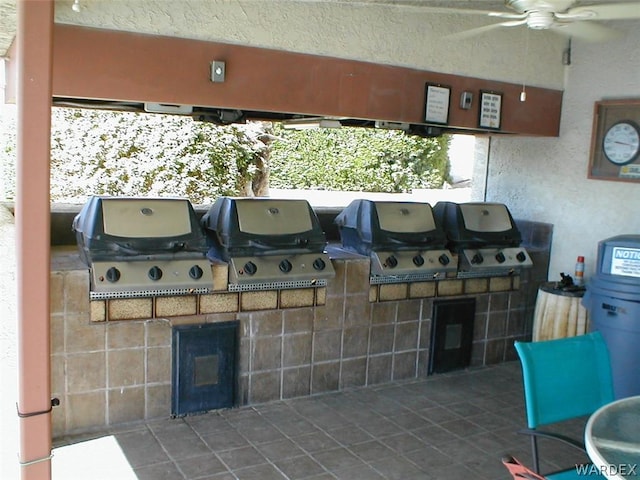 view of patio with ceiling fan, grilling area, and area for grilling