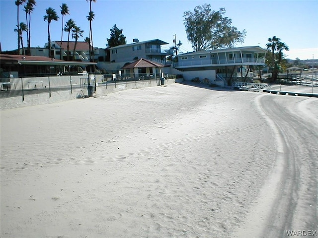 view of front facade featuring driveway and fence