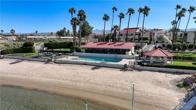 community pool with a gazebo and a residential view