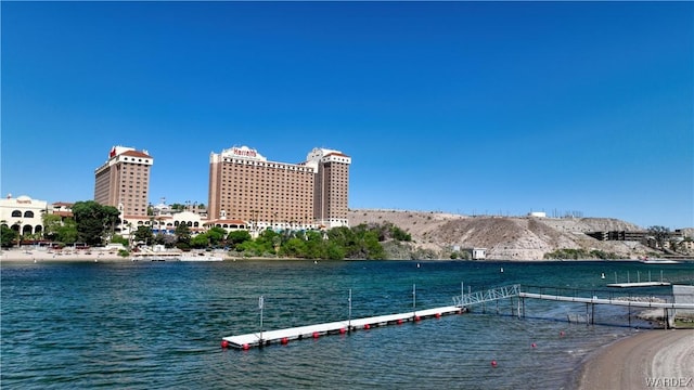 view of dock with a water view and a city view