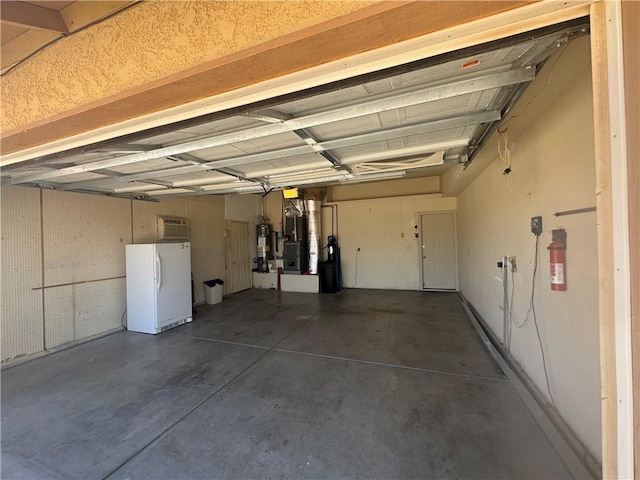 2024 E Mountain View Pl, Fort Mohave, AZ 86426 - garage featuring freestanding refrigerator, secured water heater, and heating unit