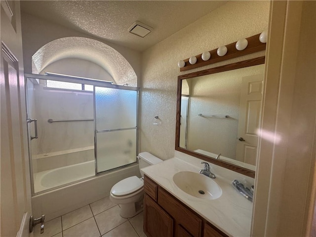 2024 E Mountain View Pl, Fort Mohave, AZ 86426 - full bath with a textured wall, toilet, vanity, bath / shower combo with glass door, and tile patterned floors