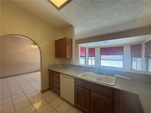 2024 E Mountain View Pl, Fort Mohave, AZ 86426 - kitchen featuring dishwasher, a sink, arched walkways, a textured ceiling, and light tile patterned floors