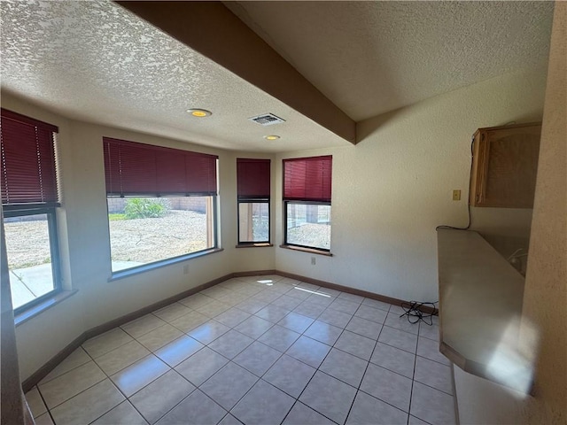 2024 E Mountain View Pl, Fort Mohave, AZ 86426 - spare room featuring a textured ceiling, light tile patterned flooring, and baseboards