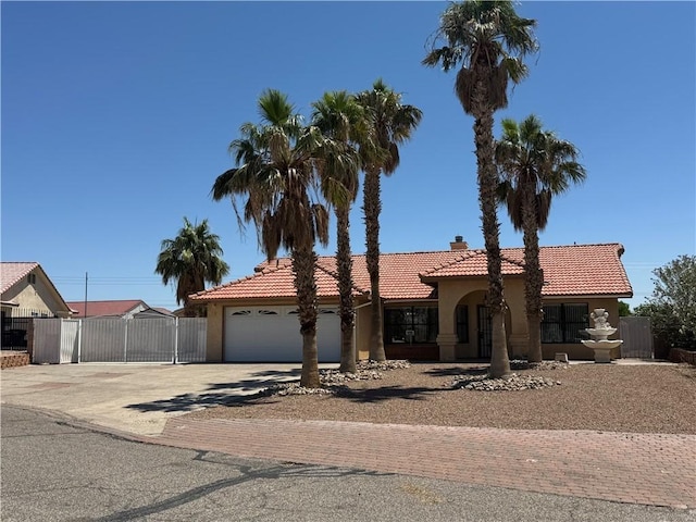 2024 E Mountain View Pl, Fort Mohave, AZ 86426 - view of front of property featuring concrete driveway, stucco siding, a tiled roof, and a garage