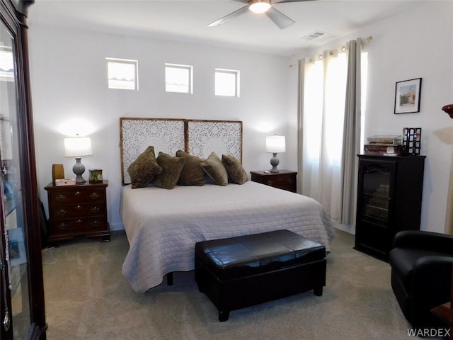 carpeted bedroom featuring visible vents and ceiling fan