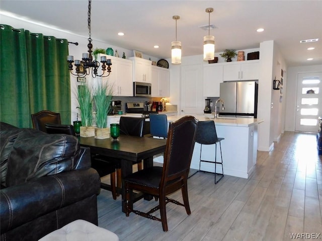 dining room featuring light wood-style flooring, visible vents, and recessed lighting