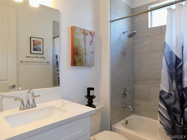 bathroom with shower / bathtub combination with curtain, vanity, and toilet