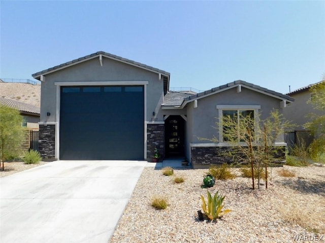 view of front facade featuring stone siding, a tile roof, driveway, and stucco siding