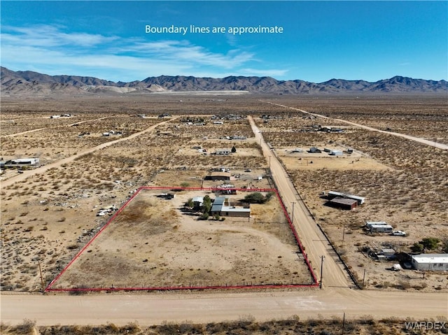 drone / aerial view featuring view of desert and a mountain view