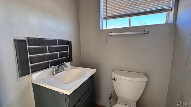 half bathroom with toilet and vanity