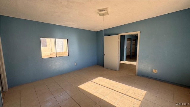 spare room with light tile patterned floors