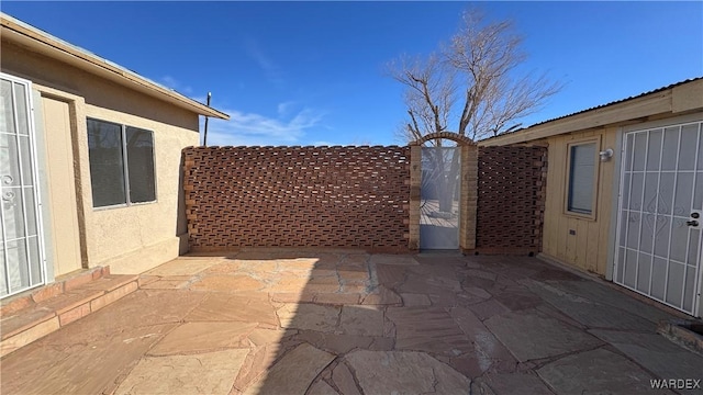 view of patio / terrace with a gate