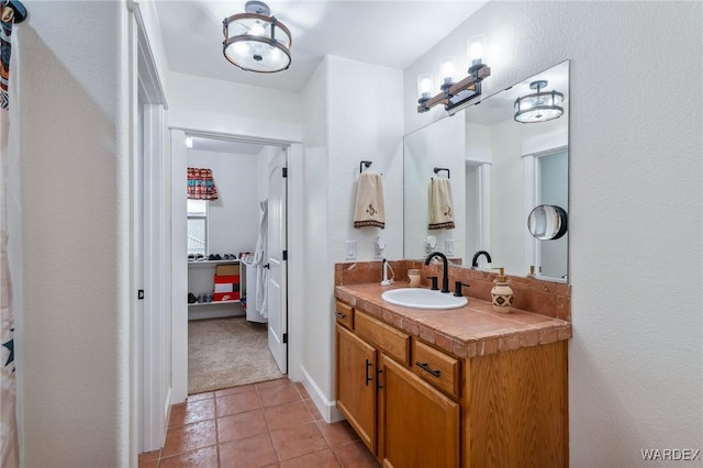 bathroom featuring a closet, tile patterned flooring, and vanity