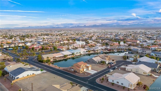 birds eye view of property with a water view and a residential view