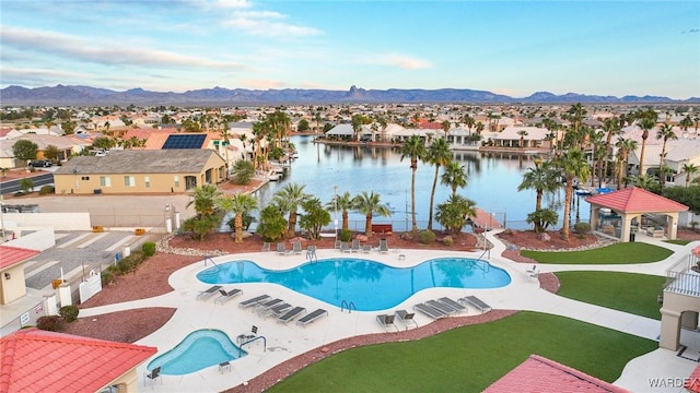 pool with a lawn, a patio, a residential view, a gazebo, and a water and mountain view