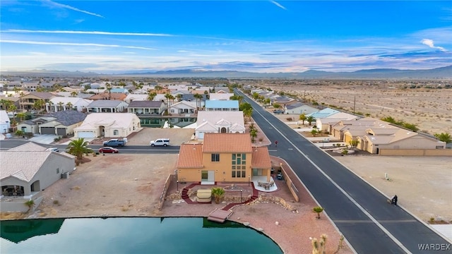 drone / aerial view featuring a water view and a residential view