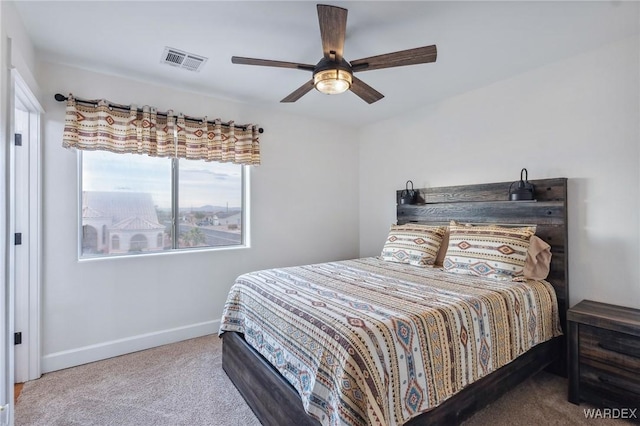 carpeted bedroom featuring baseboards, visible vents, and ceiling fan