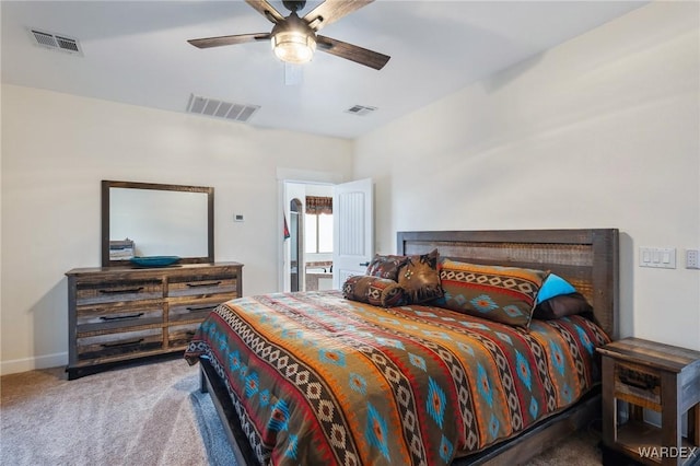 bedroom with baseboards, visible vents, and light colored carpet