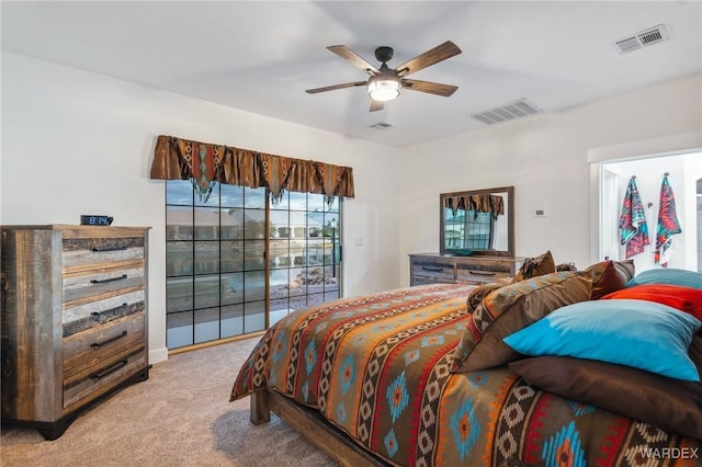 bedroom with light carpet, access to exterior, and visible vents