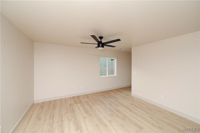 empty room with light wood finished floors, ceiling fan, and baseboards