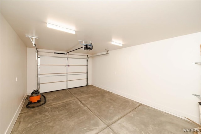 garage with a garage door opener and baseboards