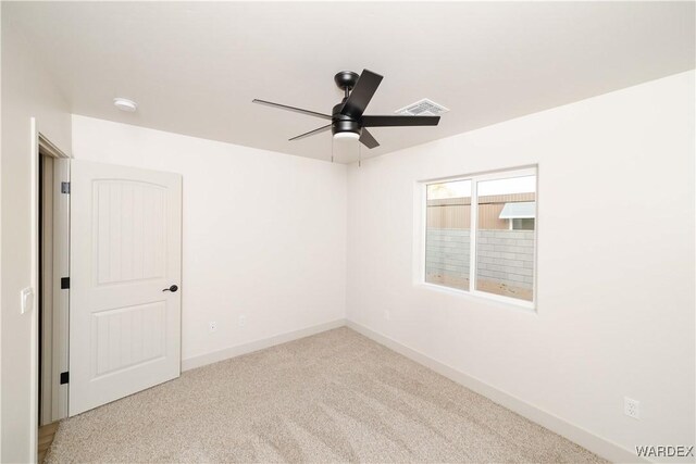 unfurnished room with light carpet, visible vents, baseboards, and ceiling fan