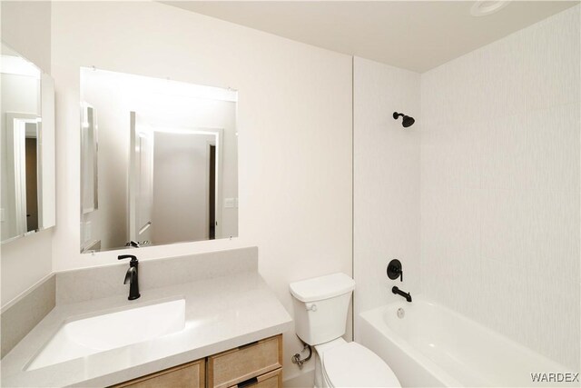 bathroom featuring shower / bathtub combination, toilet, and vanity