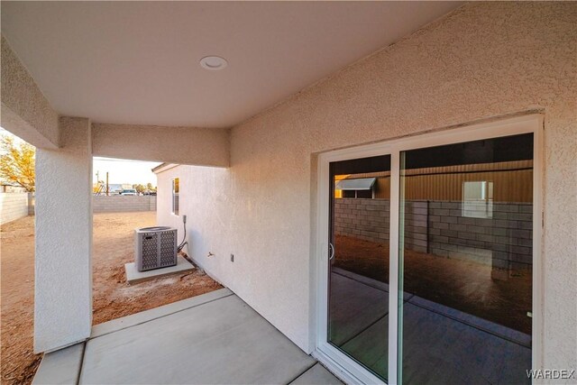 view of patio with fence and central AC unit