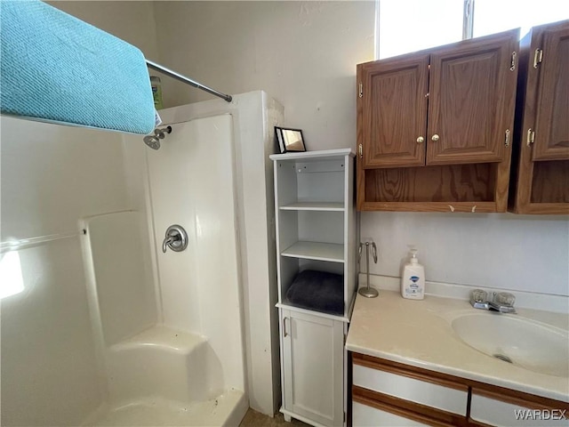 bathroom featuring a shower stall and vanity