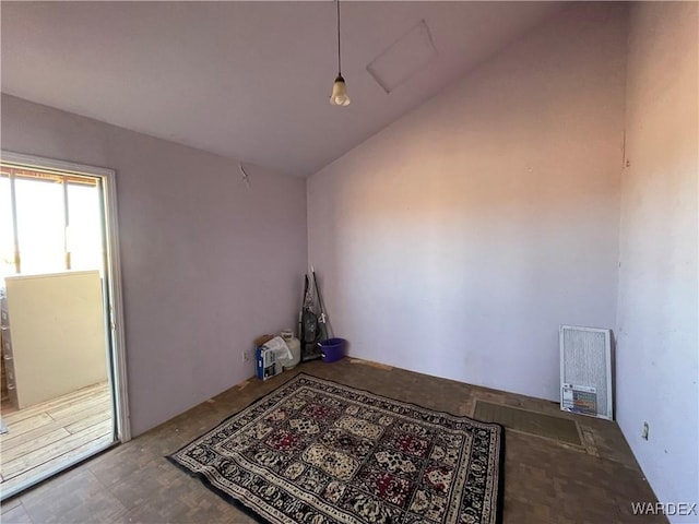 unfurnished room featuring vaulted ceiling