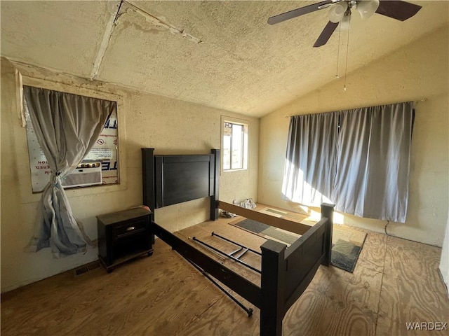 bedroom featuring cooling unit, wood finished floors, visible vents, a ceiling fan, and vaulted ceiling