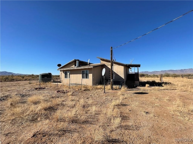 exterior space with a rural view and a mountain view