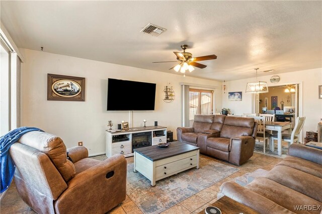 living room featuring visible vents and a ceiling fan